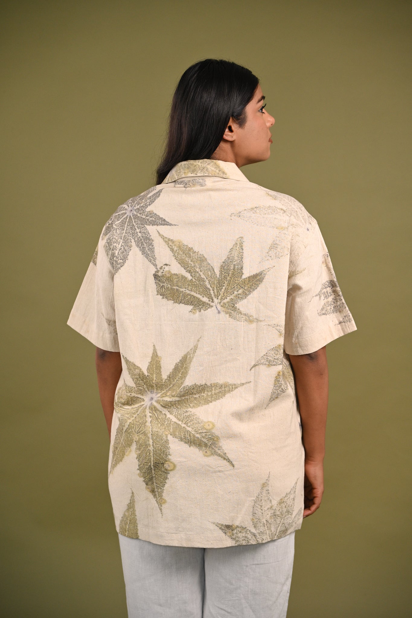 Back view of the Gia Shirt, featuring subtle castor leaf eco-prints on breathable, handwoven Kala Cotton, embodying sustainable simplicity.