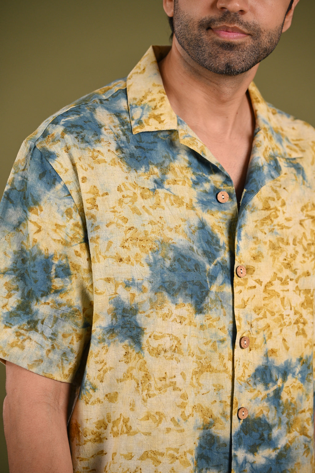 Close-up of the Aayah Shirt’s eco-printed Indigo and marigold petal patterns, highlighting the natural textures and artisanal craftsmanship of Kala Cotton.