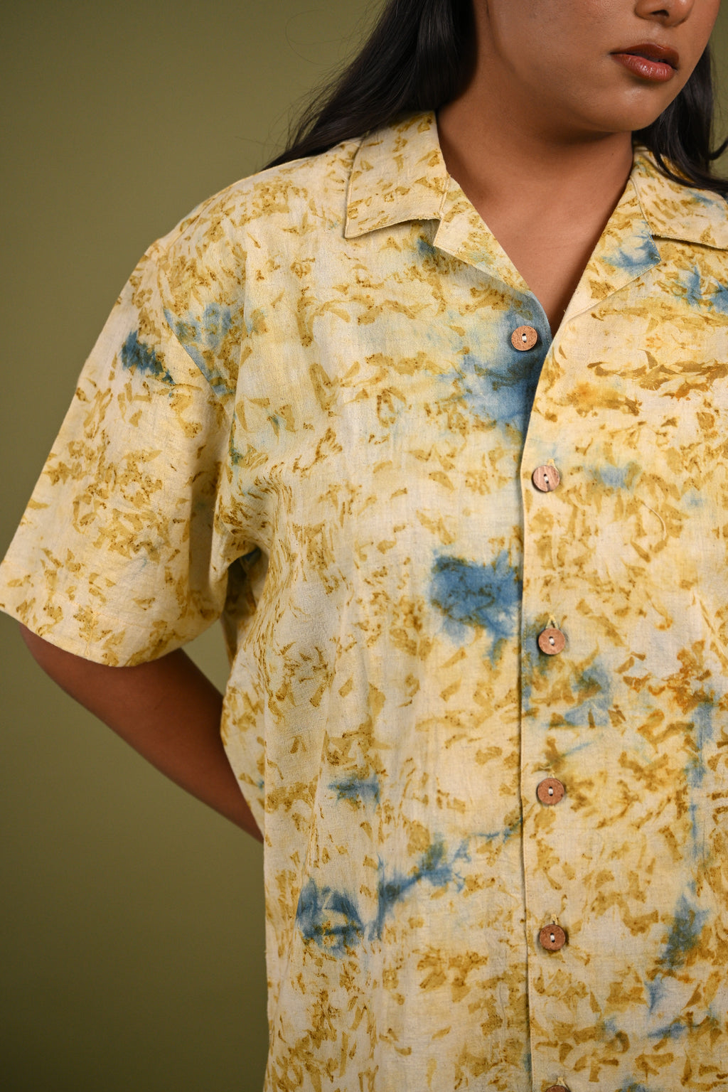 Close-up of the Aayah Shirt’s eco-printed Indigo and marigold petal patterns, highlighting the natural textures and artisanal craftsmanship of Kala Cotton.