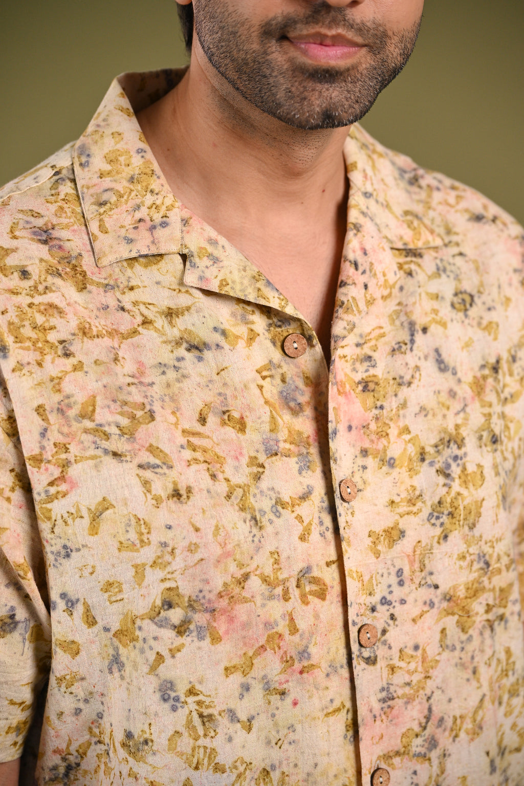 Close-up of the Iris Shirt’s eco-printed madder root, rose petals, and marigold petal patterns, highlighting the rich hues and artisanal craftsmanship of Kala Cotton.