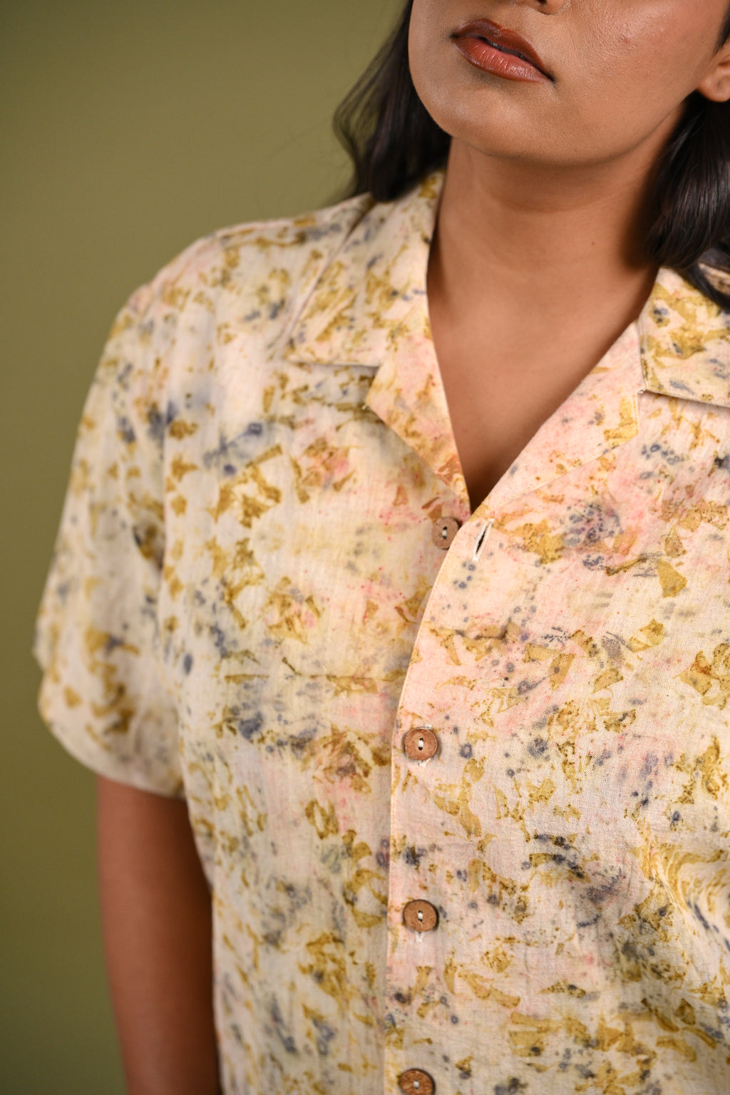Close-up of the Iris Shirt’s eco-printed madder root, rose petals, and marigold petal patterns, highlighting the rich hues and artisanal craftsmanship of Kala Cotton.