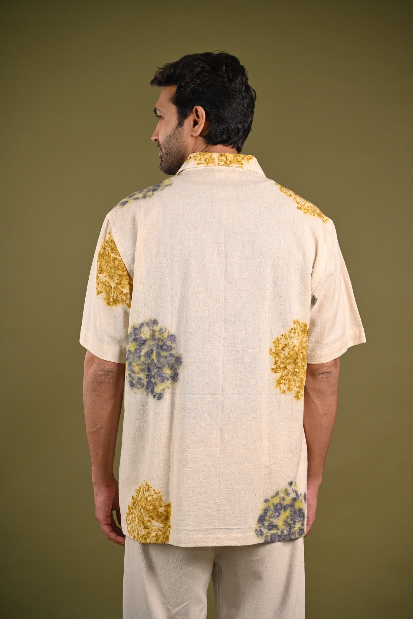 Back view of the Ehsal Shirt, featuring a subtle yet intricate eco-printed circular pattern on soft, handspun cotton, embodying slow fashion principles.