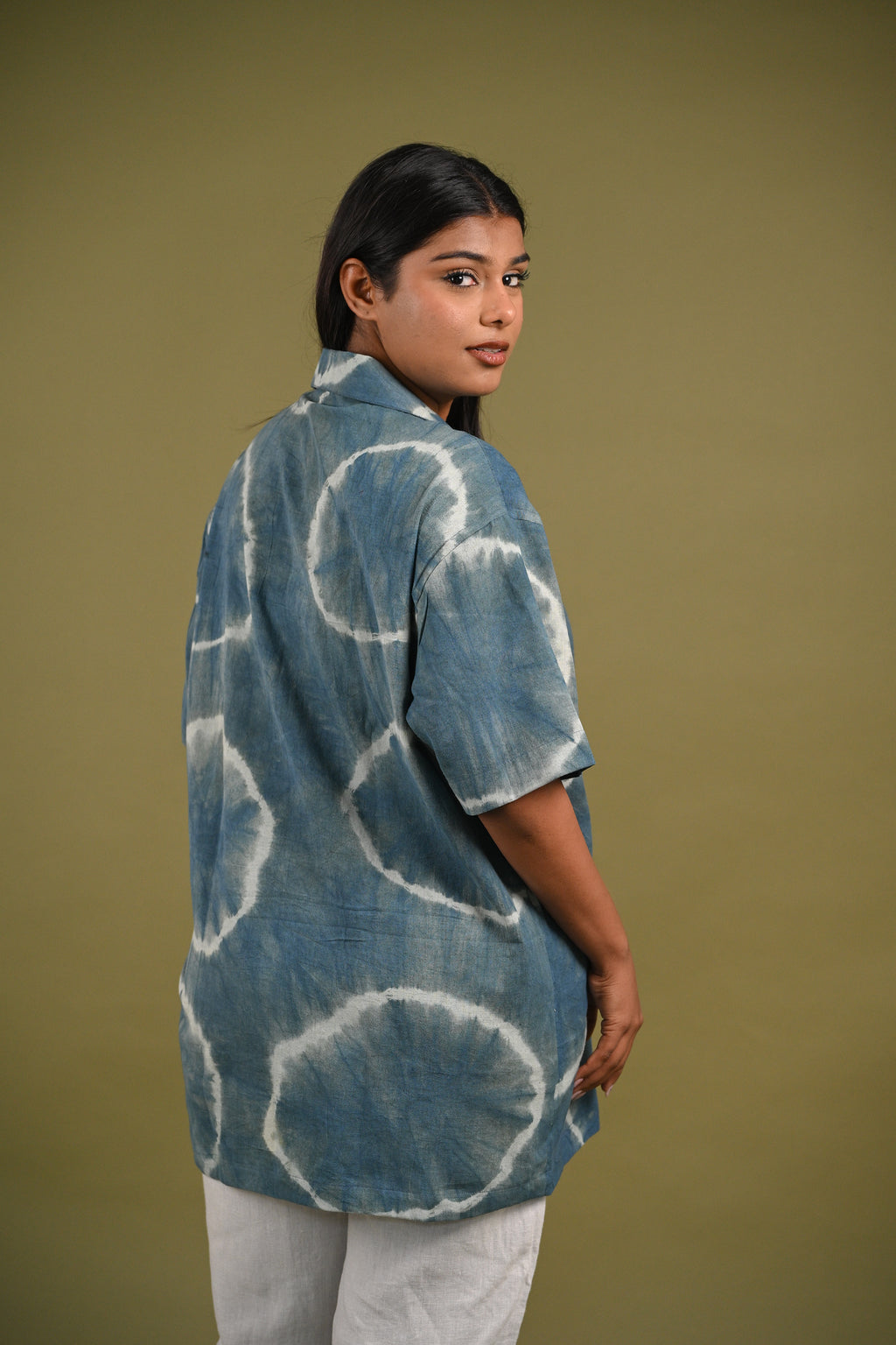 Back view of the Nilima Shirt, featuring subtle Shibori resist-dyed patterns in deep indigo on handwoven cotton, a true celebration of slow fashion.