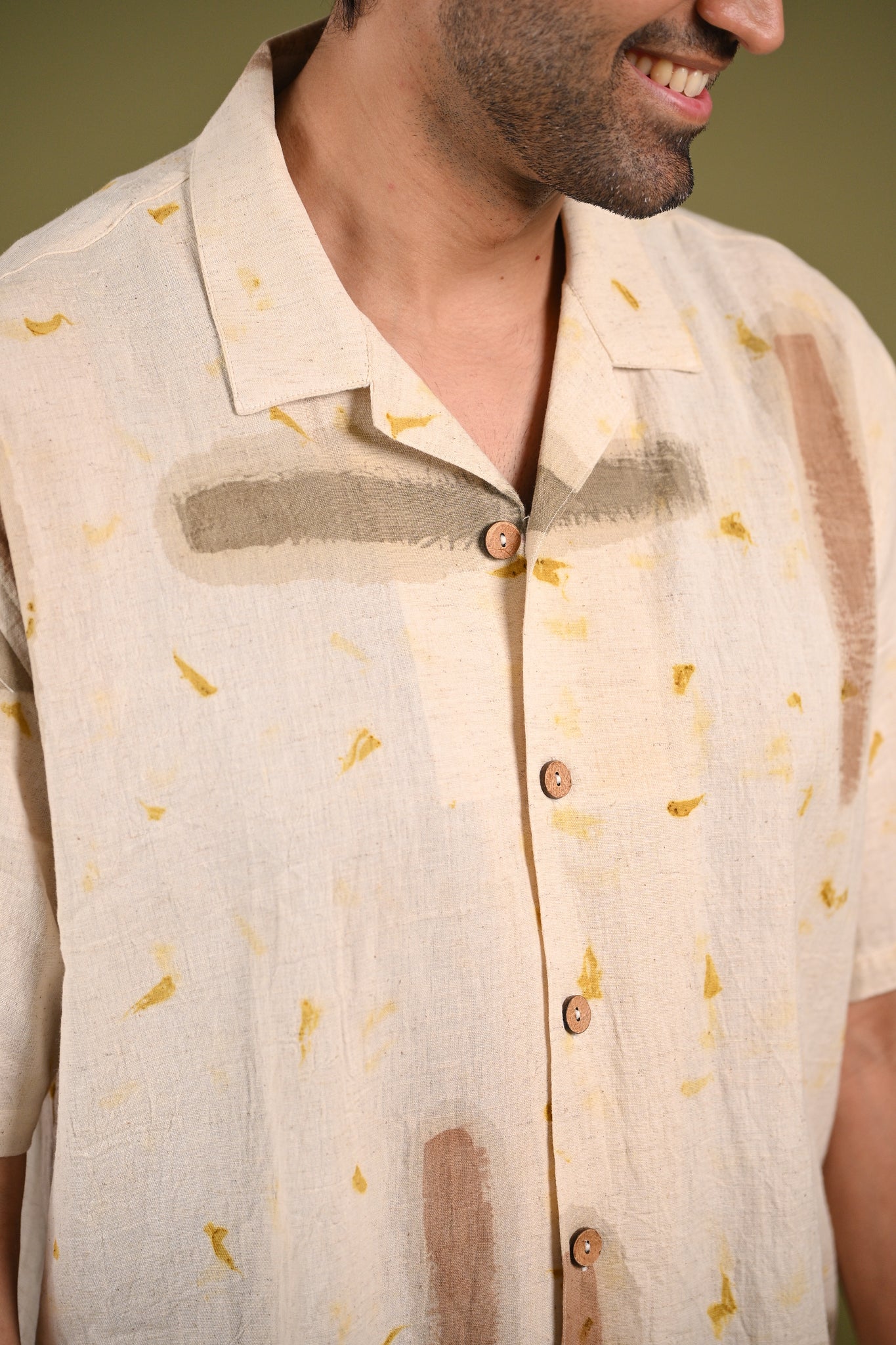 Close-up of the Nagma Shirt’s eco-printed marigold petals and hand-painted natural pigments, emphasizing the organic texture and artisanal craftsmanship.