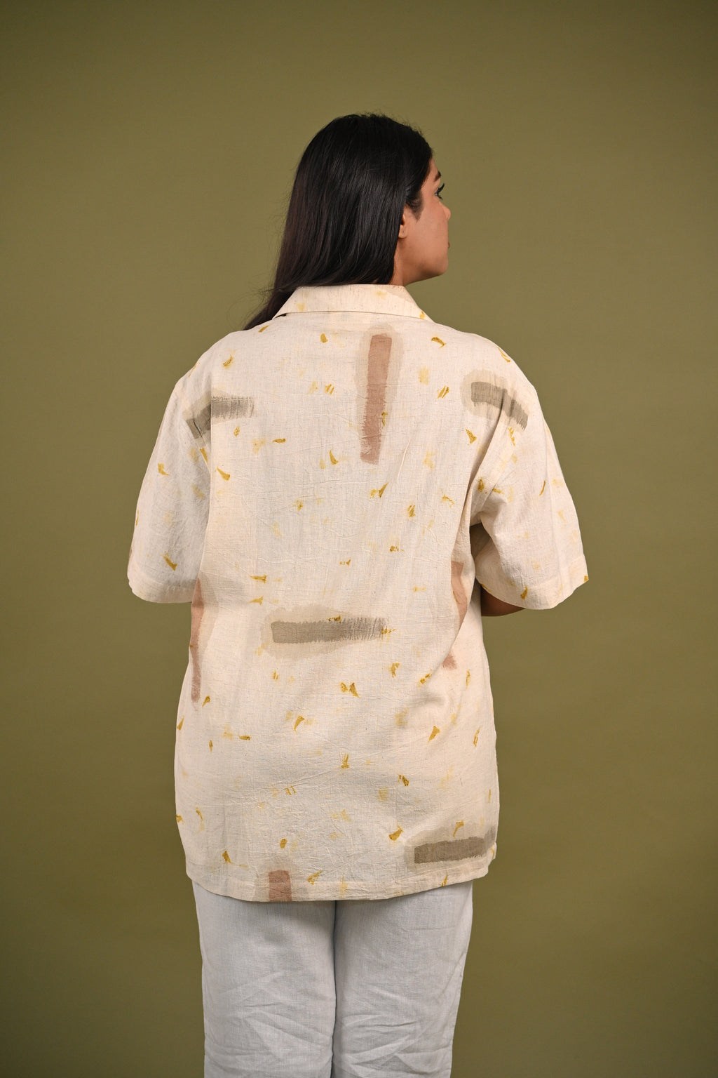 Back view of the Nagma Shirt, featuring a minimalist design with a subtle play of eco-printed marigold petals and hand-painted details on handwoven cotton.